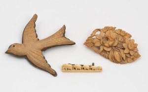 An antique carved ivory floral brooch, 19th century, together with an antique carved ivory elephant procession brooch, and an unusual carved wood and metal swallow brooch, (3 items), ​​​​​​​the floral brooch 6cm wide