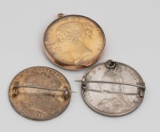 An 1844 English silver crown with gilt finish and enamel overlay mounted in 9ct rose gold as a pendant, together with an 1818 Georgian silver crown with enamel highlights mounted as a brooch, and an 1887 English silver crown coin mounted as a brooch, 19th - 2