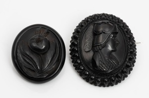 Two antique carved jet brooches, 19th century, 5cm and 4cm high.