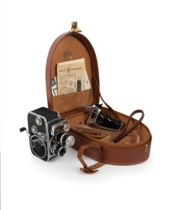 BOLEX-PAILLARD: D8L double-8 movie camera, c. 1958, in matching leather case with pistol-grip attachment, three additional accessories, and printed matter.
