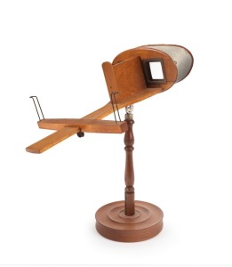 1900 PARIS EXPOSITION UNIVERSELLE: James M. Davis 'Saturn' handheld stereoscope with 'Exposition Universelle Internationale 1900' logo embossed on metal visor, 32.5cm high on attached stand.