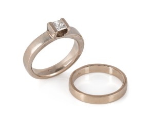 A pair of 18ct white gold rings, one set with a Princess-cut diamond, total weight 11.95 grams