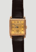 Dunklings&nbsp;"RIVANA"&nbsp;gents tank style manual wristwatch. Square dial with Arabic numerals and subsidiary seconds at the 6 position. 15 jewel Swiss movement in a 9ct gold case made by Handley, housed in a period "Dunklings The Jewellers"&nbsp;branded case, circa 