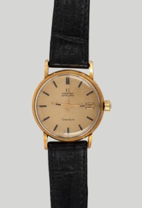 A gents gold wristwatch. Omega Geneve automatic dial with date aperture&nbsp;and baton hour indicators. Replaced Swiss manual movement, the&nbsp;case back marked 'DOXA' Swiss made 18K. 0.750. 20th century.36cm wide including crown.