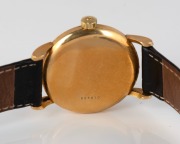 A gents gold wristwatch. Omega Geneve automatic dial with date aperture&nbsp;and baton hour indicators. Replaced Swiss manual movement, the&nbsp;case back marked 'DOXA' Swiss made 18K. 0.750. 20th century.36cm wide including crown. - 2