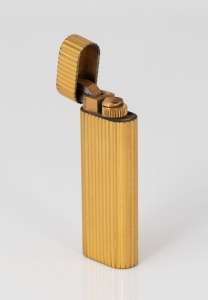 CARTIER, PARIS gold plated oval Roller cigarette lighter, 20th century, maker's details and serial number to the base: 049788, 7cm high