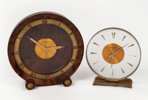 JAEGER LE COULTRE, two vintage mantle clocks.&nbsp;One in a turned amboyna wood case with brass inset cylinder feet and&nbsp;applied brass Roman numeral chapter ring. The other circular lucite plate&nbsp;with baton numerals, both with time only going barrel&nbsp;lever escape