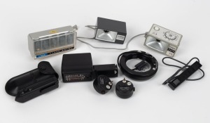 CANON: Accumulation of nine accessories - two different J-3 flash units, one Canolite ED, one Flash Quint with five flash bulbs, one Interval Timer E, one Self-Timer E, one Flash Auto Ring, one Remote Switch, and one Barcode Reader E in leatherette case. 