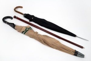 A novelty vintage&nbsp;double umbrella, a black umbrella, and a walking stick with concealed umbrella, (3 items), the largest 91cm high