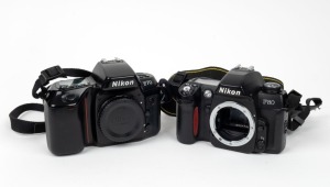 NIPPON KOGAKU: Two c. 1990s SLR cameras with Nikon neck straps - one F70 with body cap and one F80. (2 cameras)