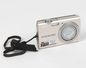 NIPPON KOGAKU: Nikon Coolpix S230 digital camera, c. 2009, with battery pack and memory card.