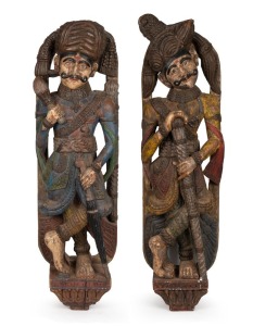 A pair of North Indian carved timber polychrome architectural statues, 20th century, the larger 108cm high