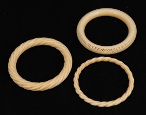 Three antique carved ivory bangles, 19th/20th century, ​​​​​​​the largest 8.7cm diameter