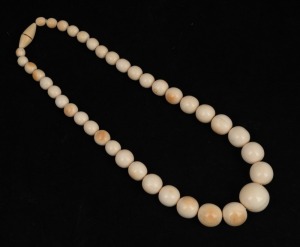 An antique graduated ivory bead necklace, 19th/20th century, ​​​​​​​the largest bead 2.5cm diameter, 65cm long.