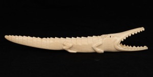 An African carved ivory crocodile ornament, early to mid 20th century, ​​​​​​​32cm long