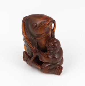 A Japanese carved horn okimono of a boy harnessing a fish, Meiji period, 19th/20th century, ​​​​​​​5cm high
