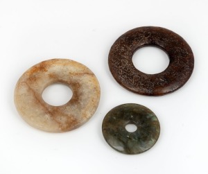 Three Chinese carved stone bi discs, unknown age, ​​​​​​​the largest 6.3cm diameter