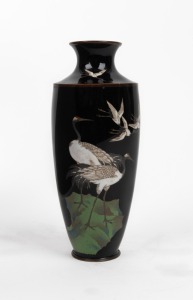 An antique Japanese cloisonne vase adorned with cranes on a black ground, Meiji Period, 19th/20th century, impressed seal mark to base, 18cm high