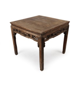 An antique Chinese elm centre table of mitred joint construction, panelled top and scroll frieze with turned decoration, 19th century, 80cm high, 92cm wide, 92cm deep.