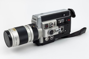 CANON: Auto Zoom 1014 Electronic Super-8 movie camera, c. 1973, with Macro 7-70mm f1.4 lens, lens cap, and Hoya UV lens filter.