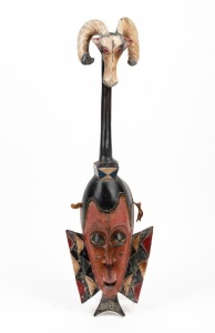 A tribal ceremonial mask with antelope totem, carved wood with polychrome finish, West African origin, 20th century, 71cm high