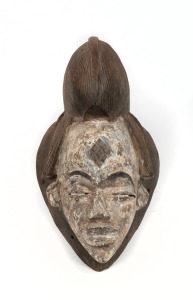 A tribal ceremonial mask, carved wood with remains of lime finish, African origin, 20th century, 40cm high
