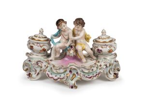 An antique Continental figural porcelain desk set in the Rococo style, 19th century, 15cm high, 25cm wide