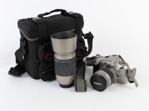 NIPPON KOGAKU: F-55 SLR camera, c. 2002, in camera case with two lenses, three lens caps, lens hood, carry strap, and instruction booklet.