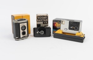 KODAK: Group of three cameras, all in maker's boxes - one c. 1938 Bantam f.8 with instruction booklet, one c. 1946 Brownie Reflex, and one c. 1982 Disc 4000 with instruction booklet. (3 cameras)