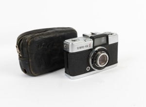 OLYMPUS: Pen S half-frame camera [#348278], c. 1960, with D. Zuiko 30mm f2.8 lens, Olympus 22.5mm Skylight 1A lens filter, and maker's leather case.