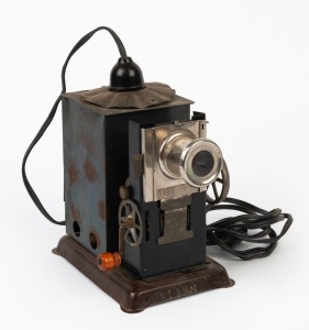 Hand-cranked magic lantern-type motion-picture projector, tin, c. 1910s, with stamp that reads 'Lion - Made in Japan' on base.