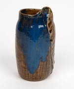 PHILIPPA JAMES pottery vase with applied gum leaf decoration and unusual brown and blue high gloss glaze, incised "Philippa James" with remains of original paper label, 17cm high - 2