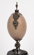 An antique emu egg ornament with silver plated mounts, emu finial and ebonised timber base, 19th century, 33cm high - 2