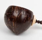 An antique coconut ladle with ivory mount and turned wooden handle, engraved "GOD THE FATHER, GIVER OF LIFE. SHIP, EMMA ROSE" with inset whalebone plaque to handle inscribed "STOLEN FROM SEAN O'REILLY - HIS LADLE", 19th century, ​​​​​​​29.5cm long overall - 3