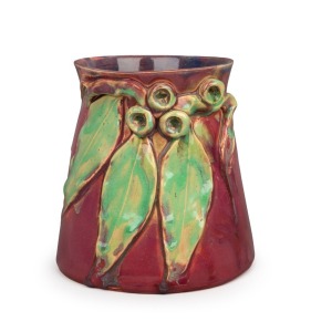 REMUED pottery vase adorned with four gumnuts and three leaves, beautifully glazed in pink and green, incised "Remued Hand Made 180/6M", 16cm high, 16cm wide