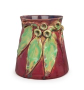 REMUED&nbsp;pottery vase adorned with four gumnuts and three leaves, beautifully glazed in pink and green, incised "Remued&nbsp;Hand Made 180/6M", 16cm high, 16cm wide