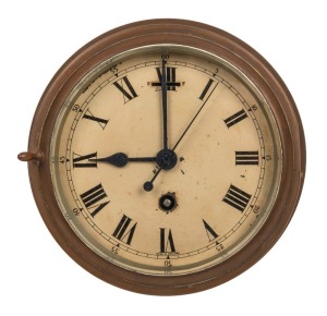 An antique ship's bulkhead clock in brass case with eight day movement and Roman numerals, 19th/20th century, 20cm diameter