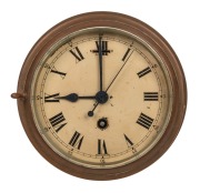 An antique ship's bulkhead clock in brass case with eight day movement and Roman numerals, 19th/20th century, 20cm diameter