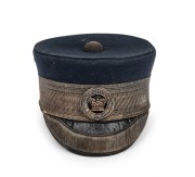 CONVICT DEPARTMENT Officer's cap with original circular badge, navy blue wool with silver thread trim and band, circa 1840s. Note: this is the only example with a silver finished hat badge known to our rooms. Rare.