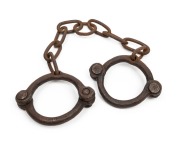 CONVICT LEG IRONS, early riveted construction with remains of broad arrow stamps, 18th/19th century, ​​​​​​​70cm wide.