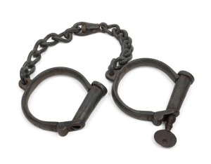 HIATT CONVICT LEG IRONS #17 on shackles and key, 19th century, 62cm long.