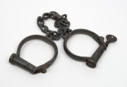 HIATT&nbsp;CONVICT LEG IRONS #17 on shackles and key, 19th century, ​​​​​​​62cm long. - 2