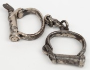 CONVICT HANDCUFFS, heavy duty example with original key and remains of nickel plating, mid 19th century, ​​​​​​​24cm wide - 2