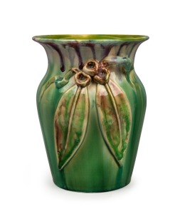 REMUED pottery vase with applied gumnuts, leaves and branch handle, glazed in green with unusual burgundy highlights, incised "Remued, Hand Made, 196/7M", 19cm high