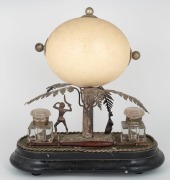 An antique Australian silver plated desk set with Aboriginal hunter figure and kangaroo mounted below an attractively carved ostrich egg decorated with gum tree, kookaburra, kangaroo and emu, 19th century, 29cm high - 2