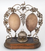 An antique Australiana&nbsp;mantle clock with silver plated mounts adorned with kangaroo, emus, ferns and flowers, mounted on a timber base, decorated with two carved emu eggs, circa 1900, 35cm high. PROVENANCE:&nbsp;The Professor Stephen Bartos Collection, Canber - 2