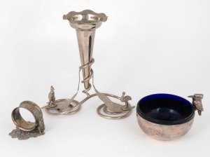 40 · An Australian silver plated single trumpet epergne decorated with gum leaves, kangaroo and emu; together with a silver plated kookaburra bowl with blue glass liner, and a silver plated napkin ring with kangaroo decoration, 19th/20th century, (3 items), the largest 18cm high