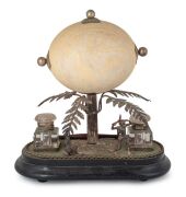 An antique Australian silver plated desk set with Aboriginal hunter figure and kangaroo mounted below an attractively carved ostrich egg decorated with gum tree, kookaburra, kangaroo and emu, 19th century, 29cm high