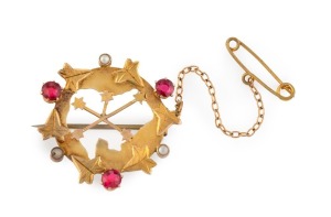 ALFRED JACKSON, of Fremantle, Western Australia, 9ct yellow gold "Southern Cross" brooch decorated with leaves, three red stones and seed pearls, 19th century, stamped "9ct" with pictorial mark, 3.1cm wide, 3.7 grams