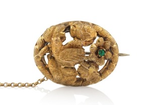 An antique Colonial Australian 15ct gold oval brooch with bird and floral motif, set with a green stone, circa 1860s, 3cm wide, 4.3 grams.